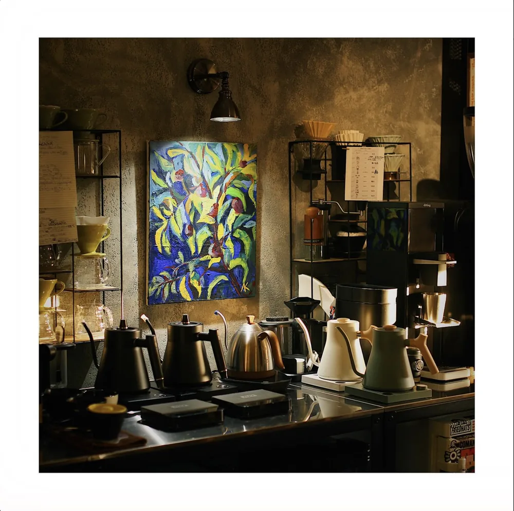 The pour-over bar at Samurai with a row of gooseneck kettles and a colourful painting on the wall